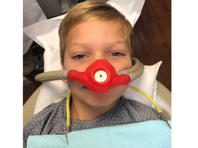 Child at dentist office with sedation equipment