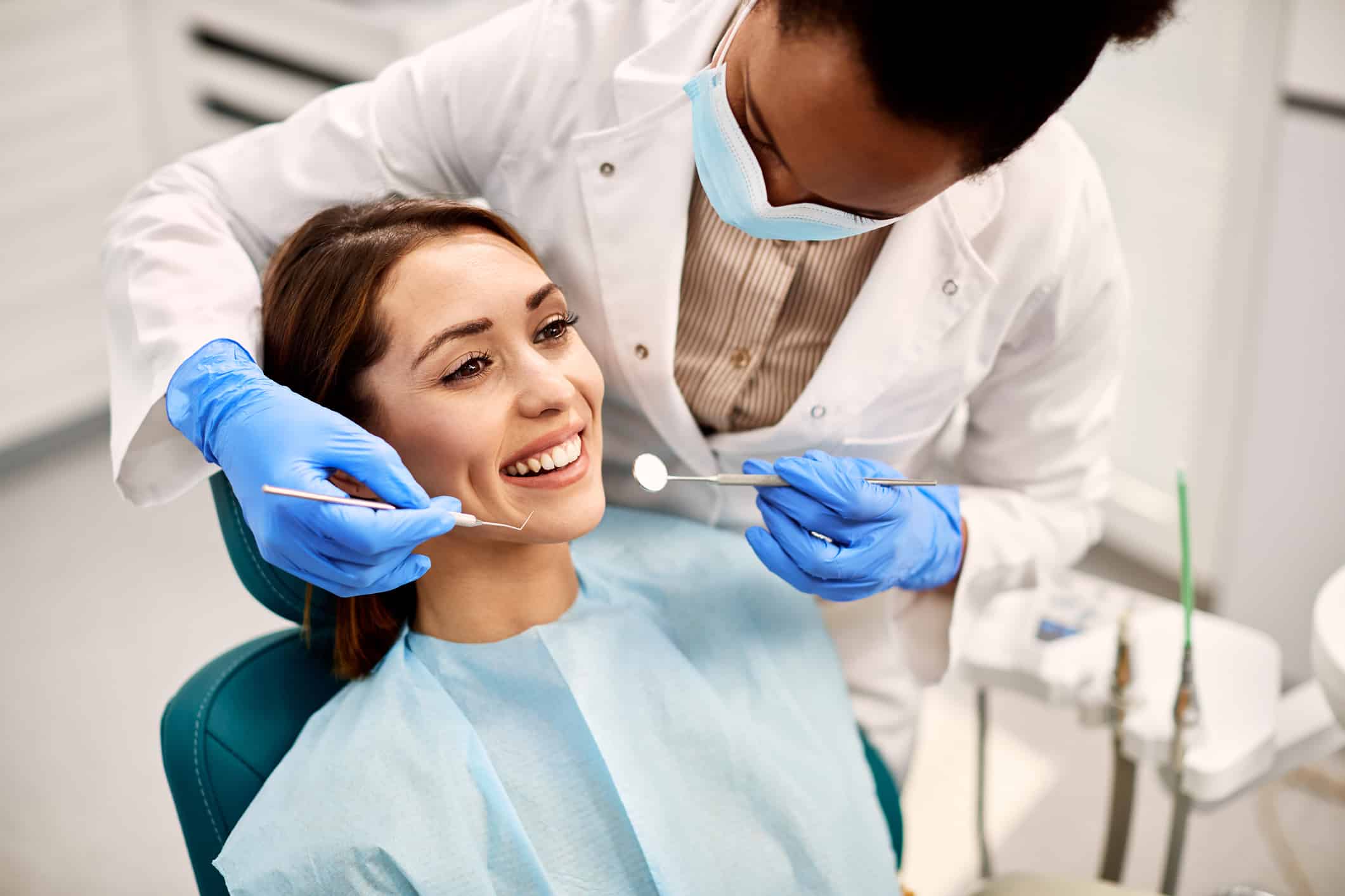 Young happy woman during dental procedure at a dentist's checkup.